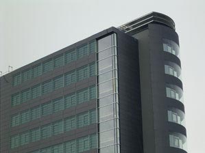 Glass facade with adjustable lamellae windows 