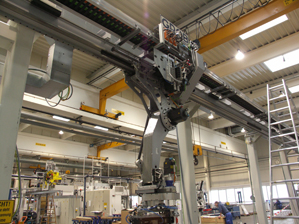 A linear gantry is being assembled in the production area.